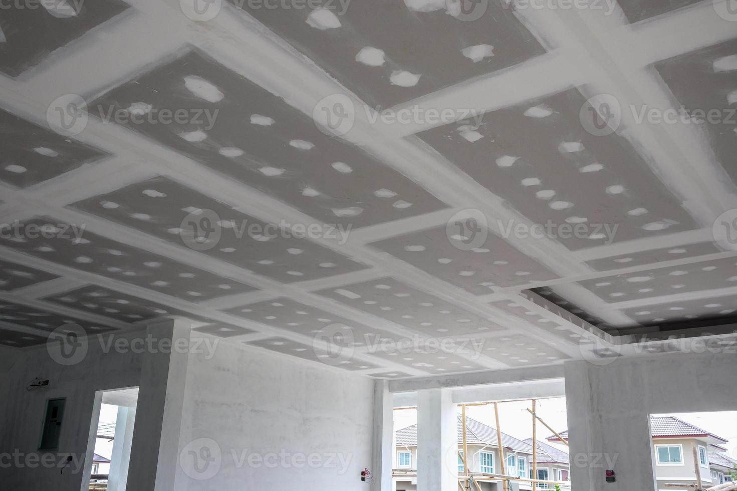 ceiling gypsum board installation at construction site photo