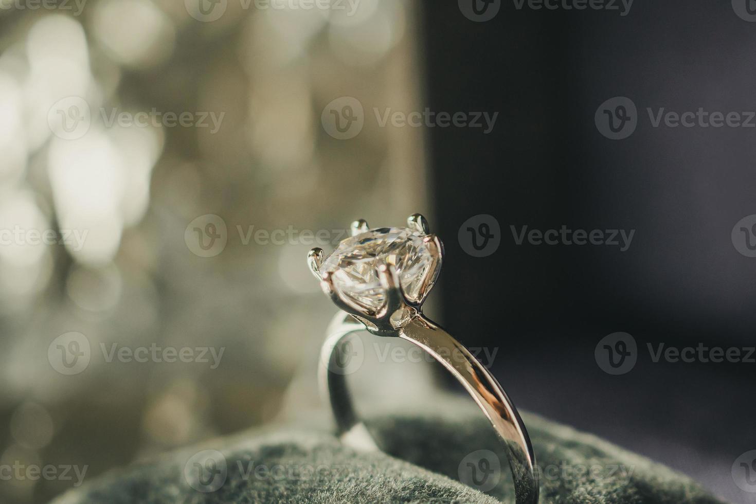 luxury engagement Diamond ring in jewelry gift box with bokeh light background photo
