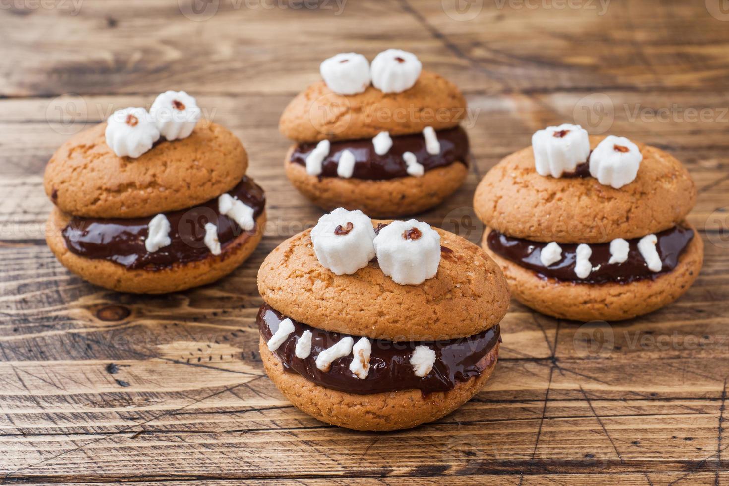 Cookies with chocolate paste in the form of monsters for Halloween photo