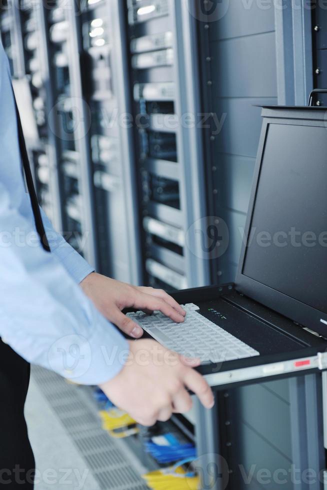 young it engineer in datacenter server room photo