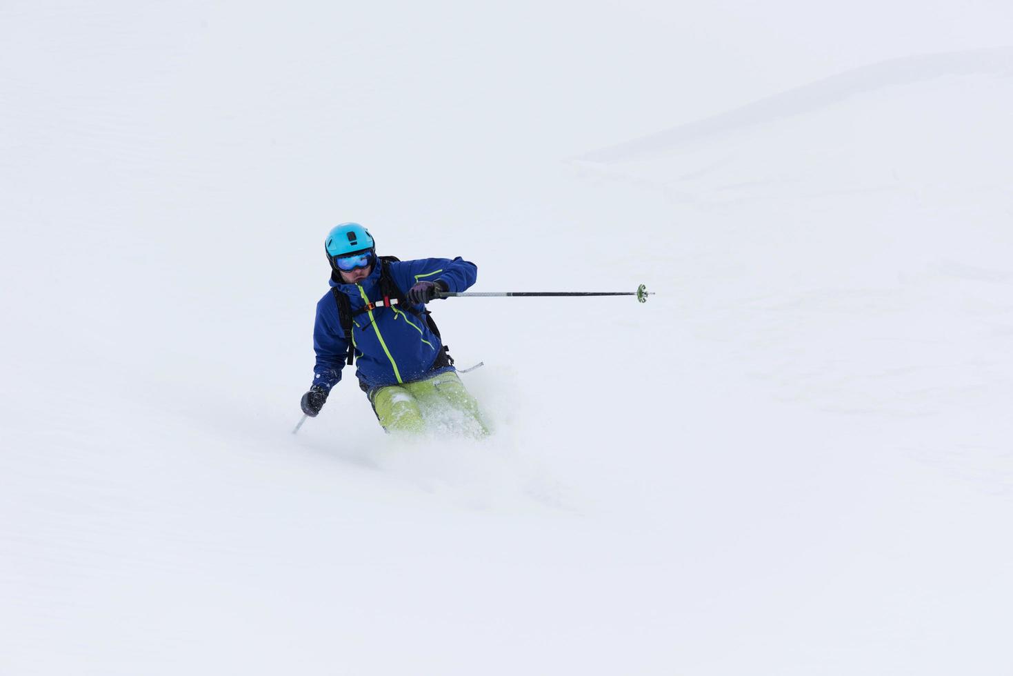 freeride skier skiing in deep powder snow photo