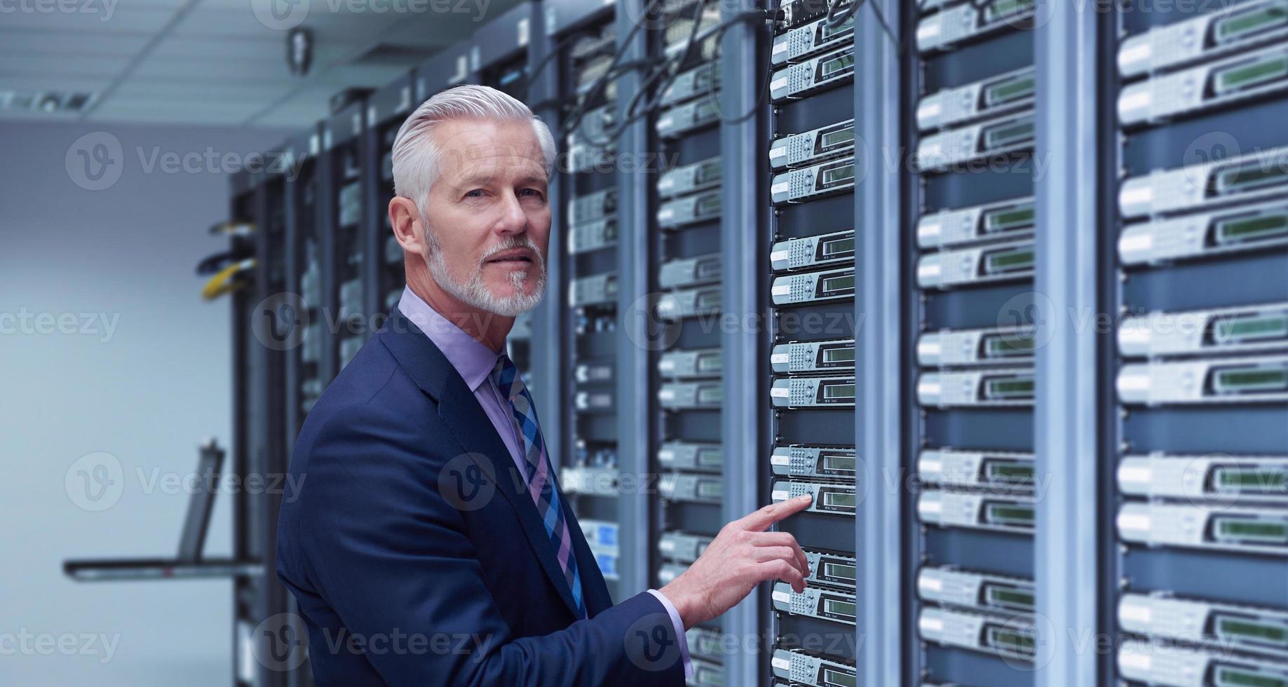 Senior businessman in server room photo