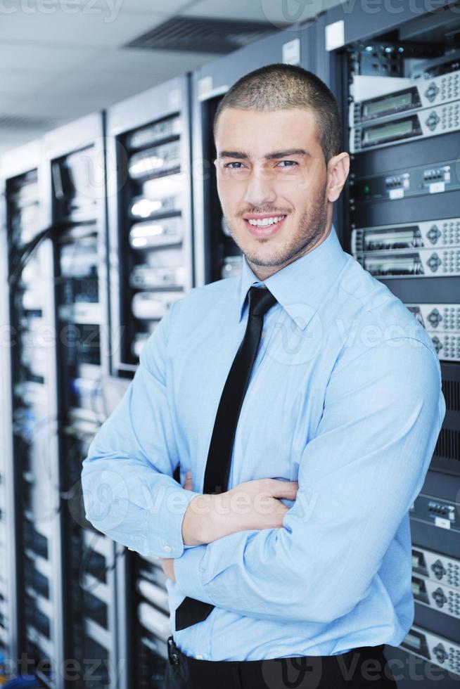 young it engineer in datacenter server room photo