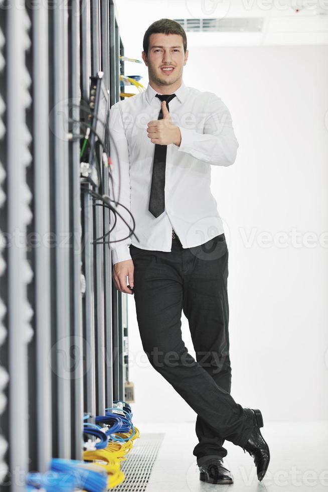 young engeneer in datacenter server room photo