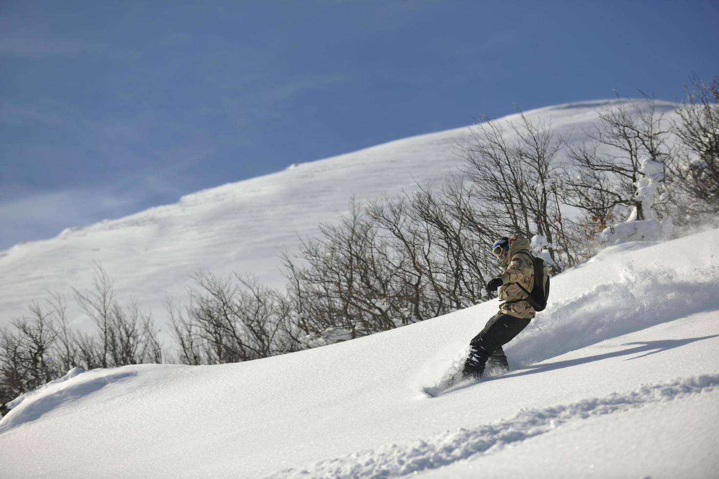 freestyle snowboarder jump and ride photo