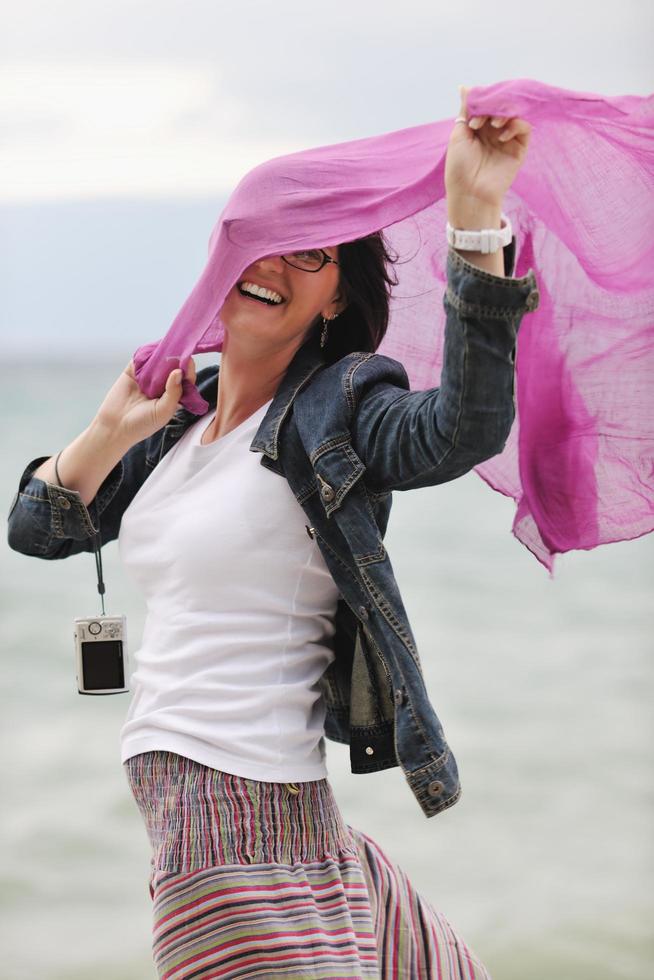 beautiful young woman on beach with scarf photo