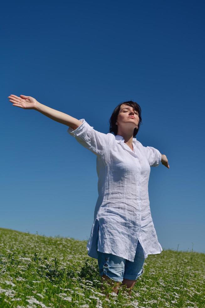 Young happy woman in green field photo