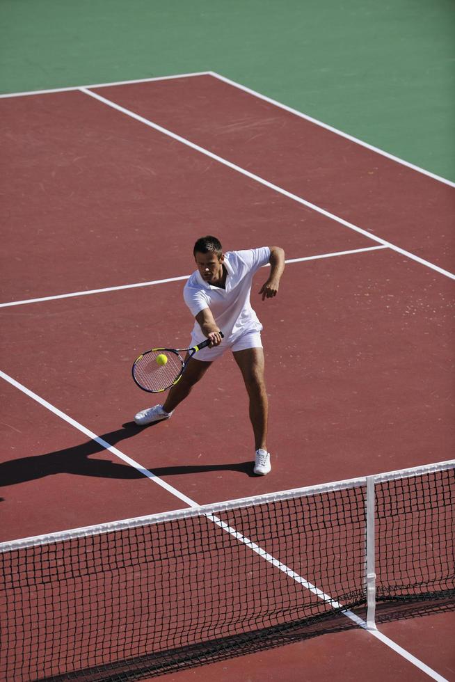 young man play tennis outdoor photo