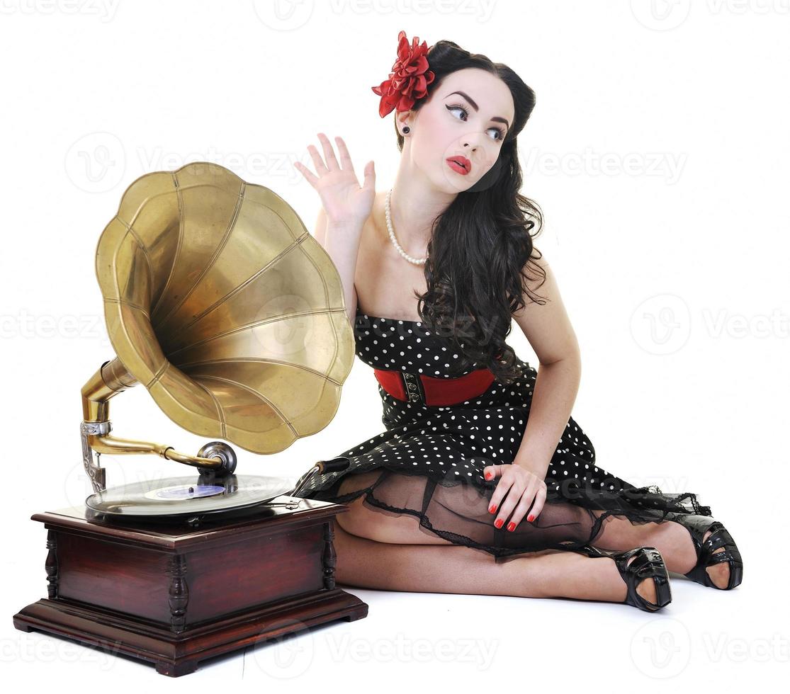 pretty girl listening music on old gramophone photo