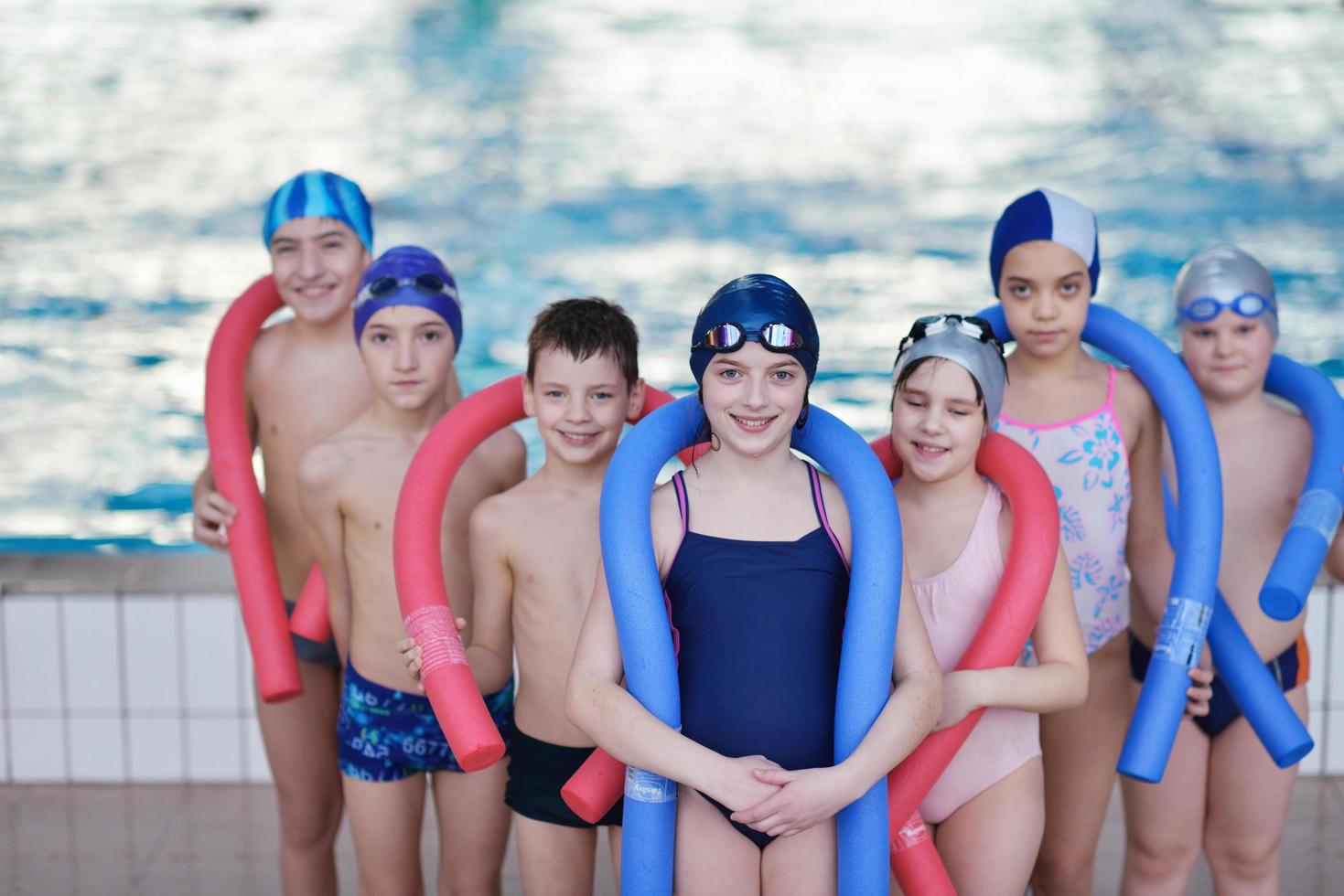 happy children group  at swimming pool photo