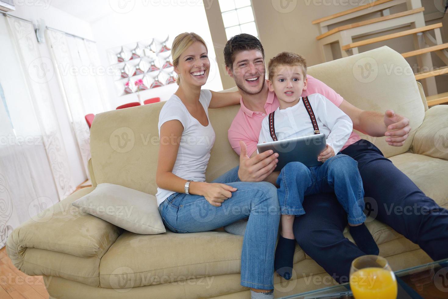 family at home using tablet computer photo