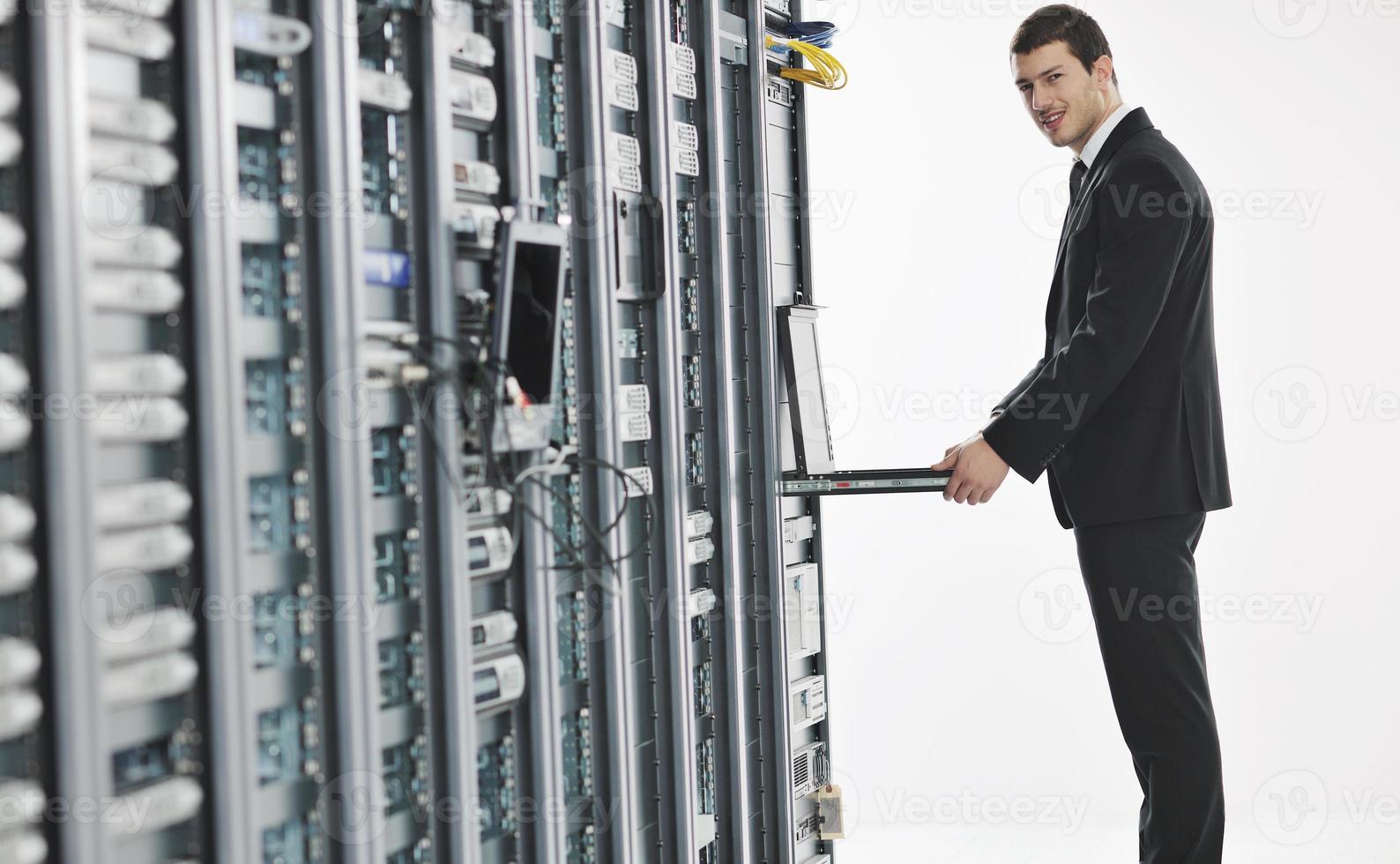 young engeneer in datacenter server room photo