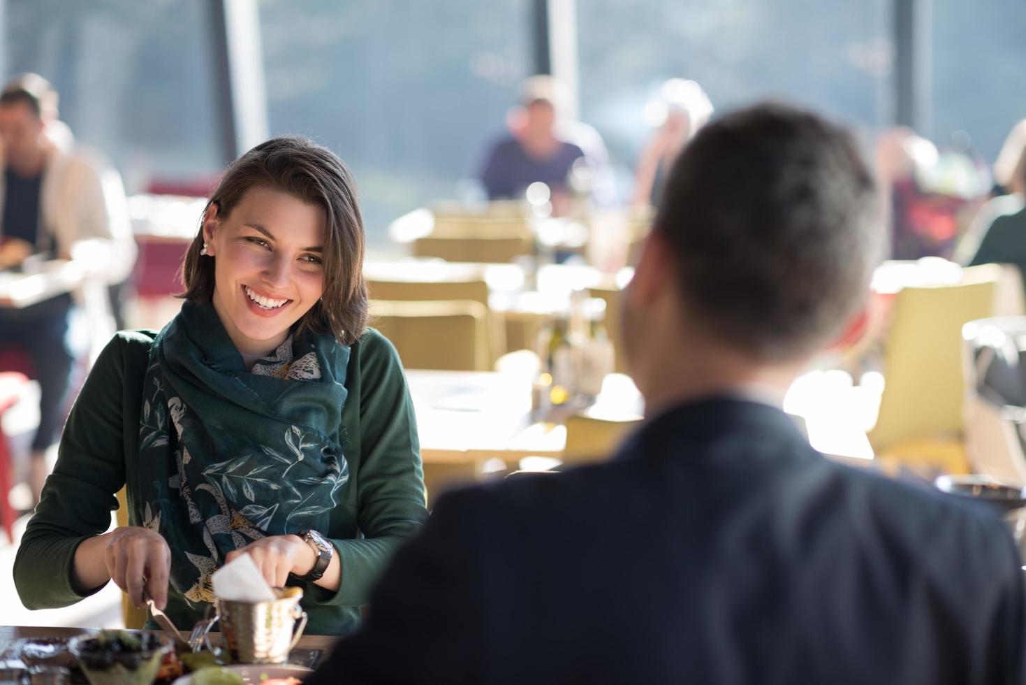 Closeup shot of young woman and man having meal. photo