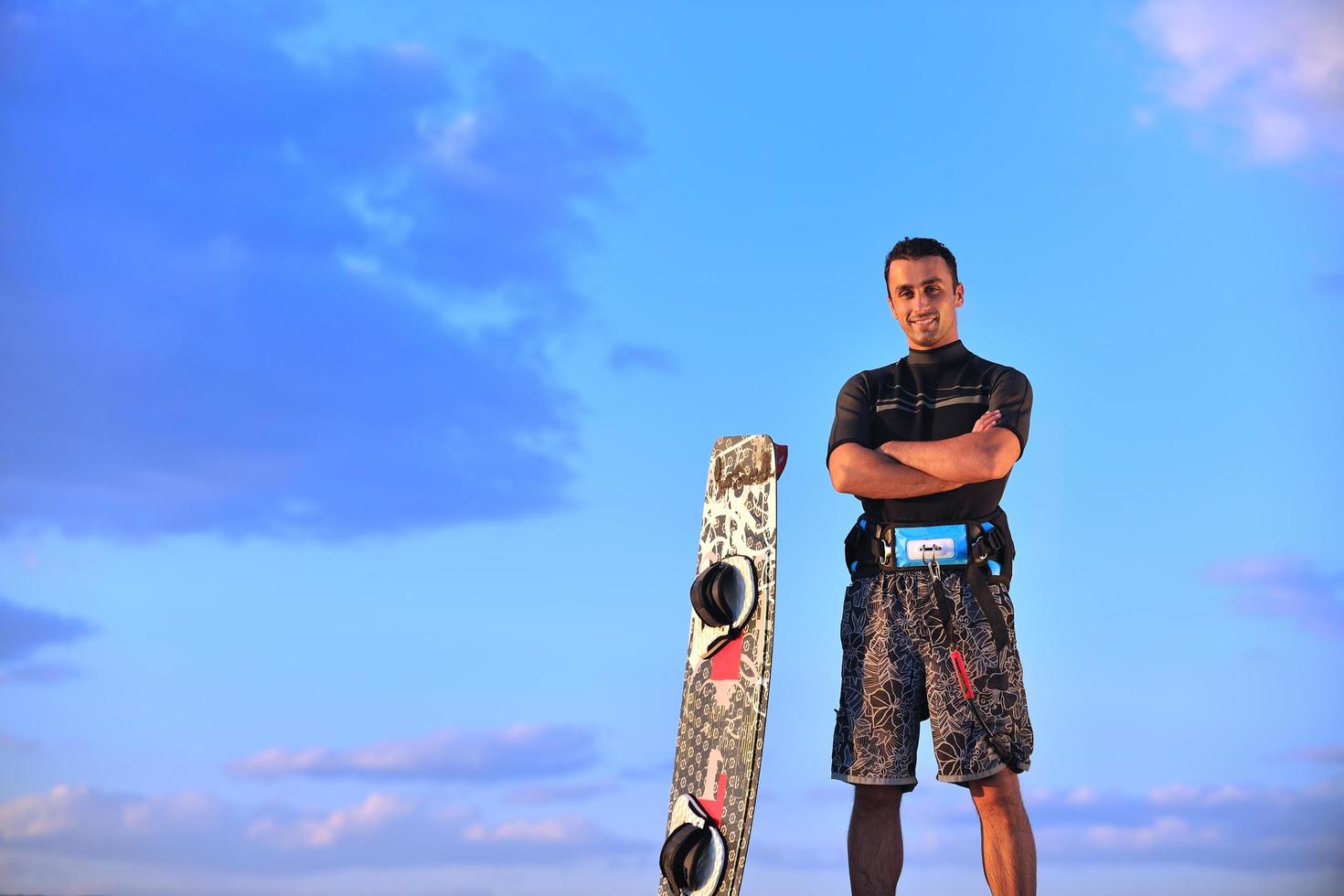 Portrait of a young  kitsurf  man at beach on sunset photo