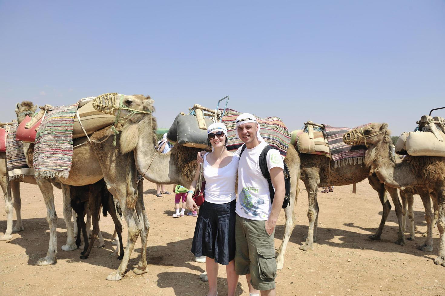 Posing with camels photo