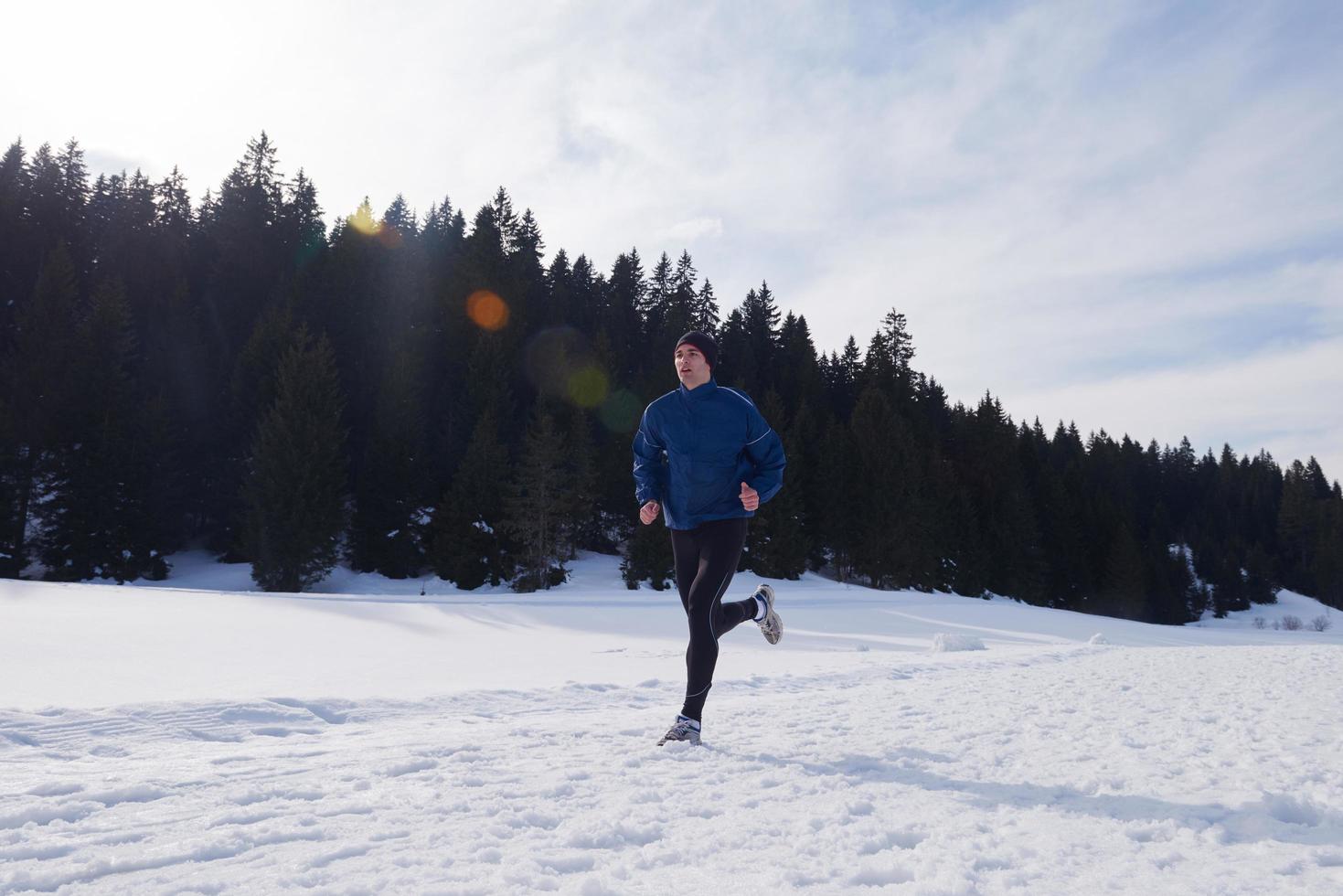 jogging on snow in forest photo