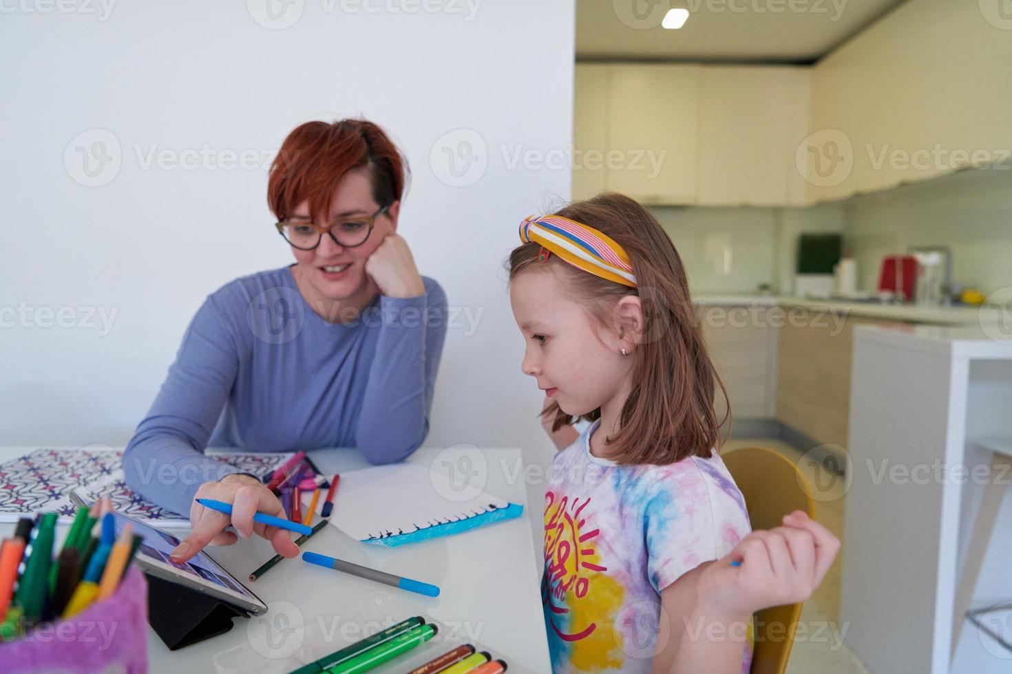 Mother and little daughter  playing together  drawing creative artwork photo