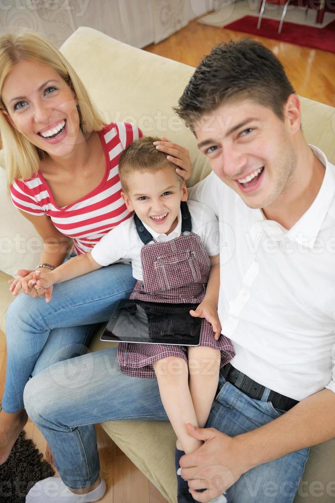 family at home using tablet computer photo