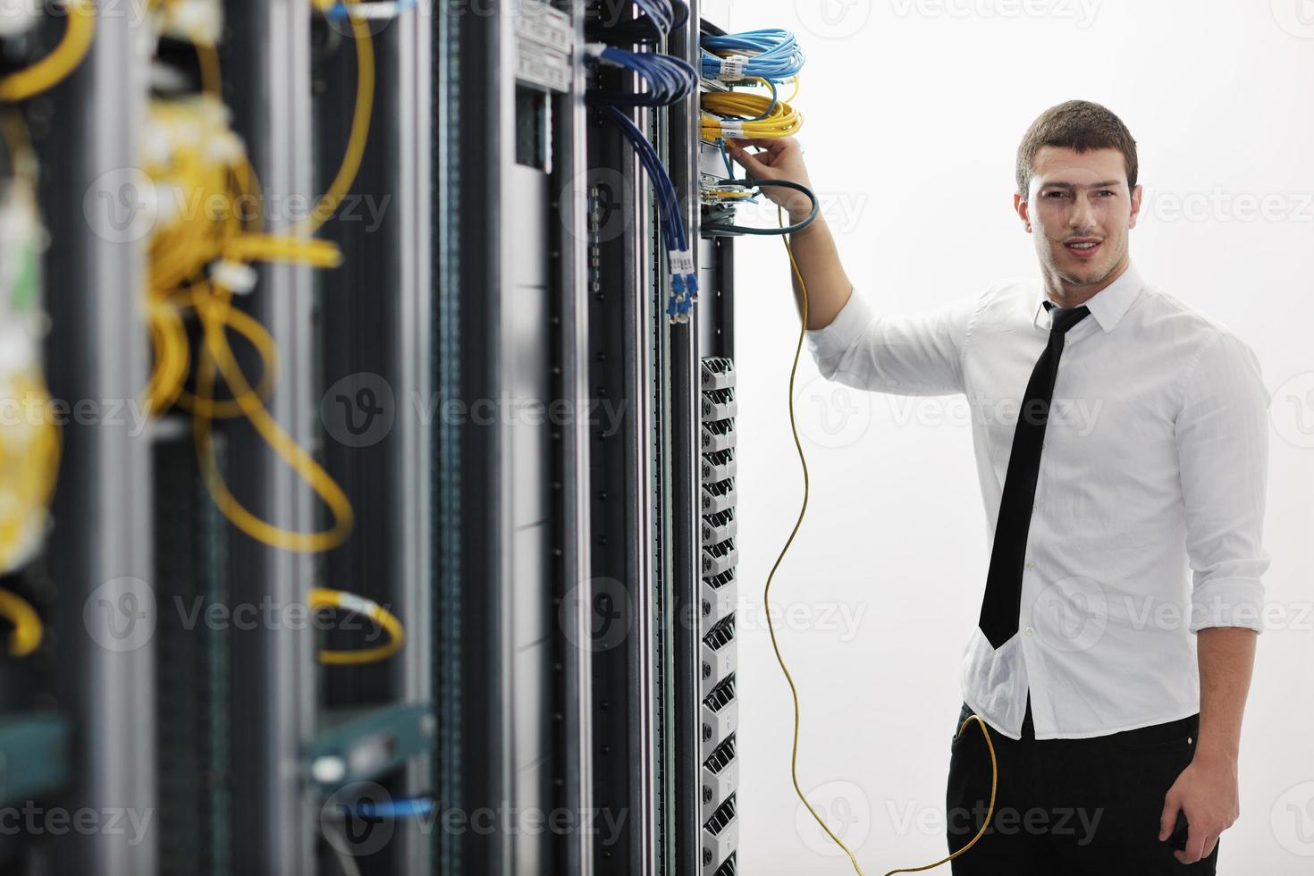 young it engeneer in datacenter server room photo