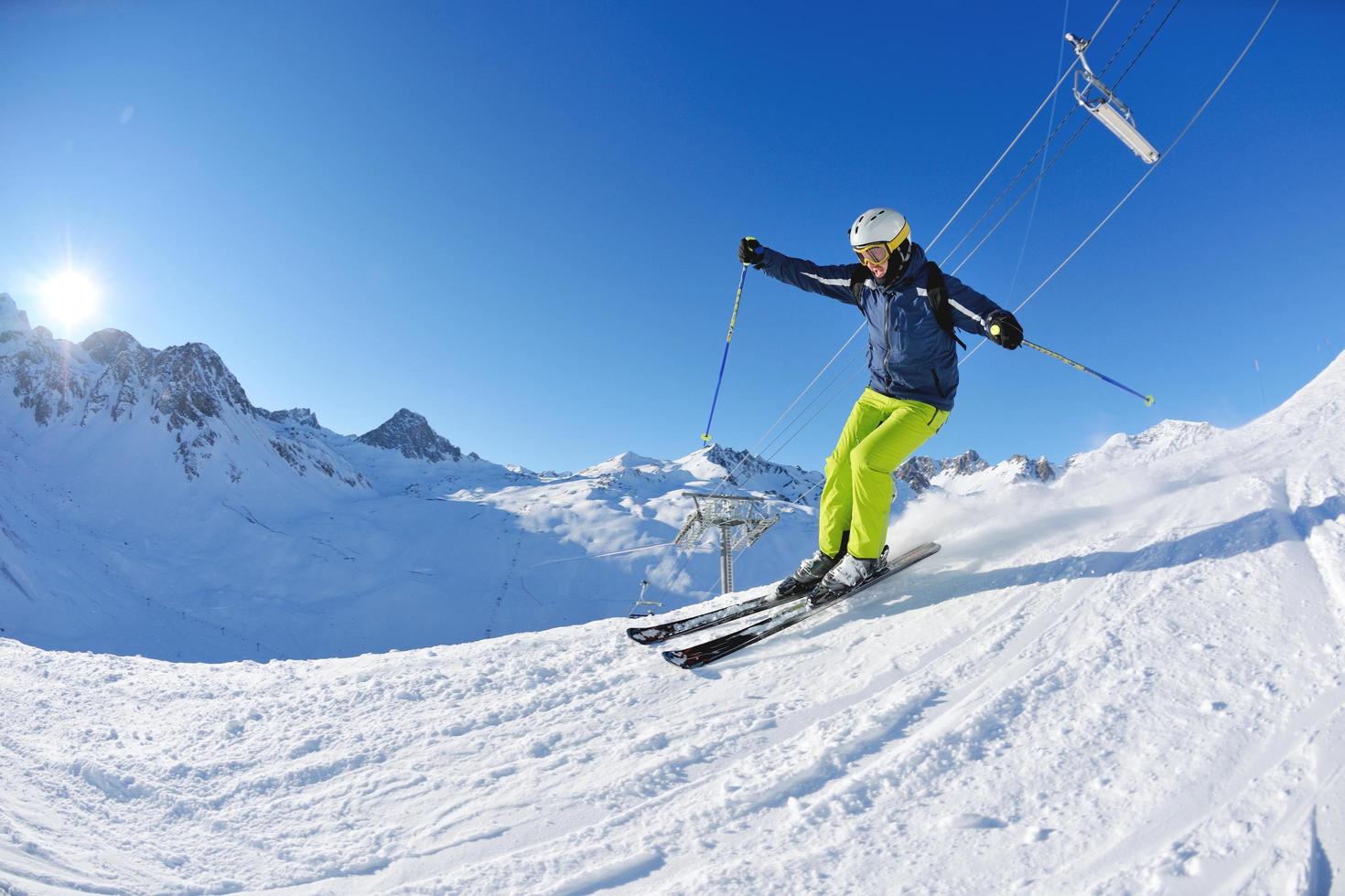 skiing on fresh snow at winter season at beautiful sunny day photo