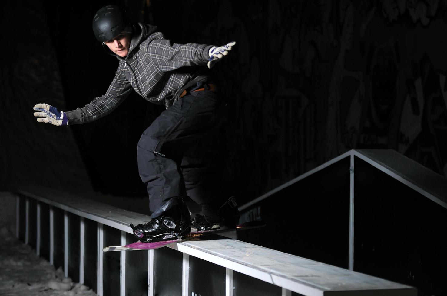 freestyle snowboarder jump in air at night photo