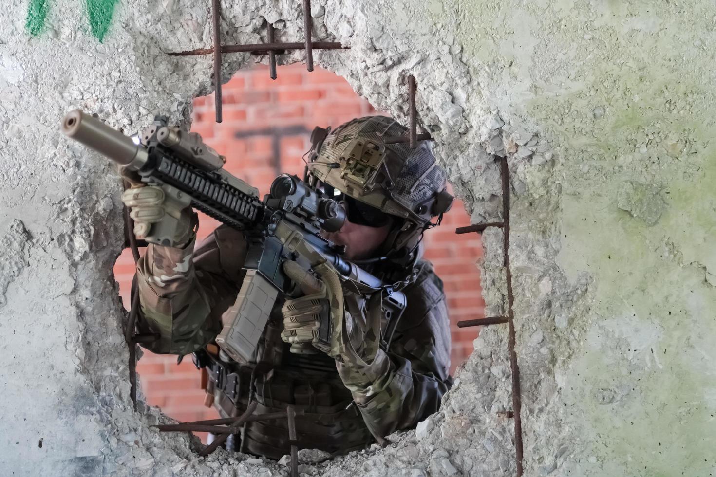 A bearded soldier in uniform of special forces in a dangerous military action in a dangerous enemy area. Selective focus photo