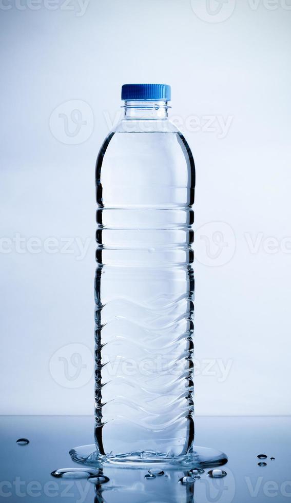 Plastic pure water bottle with water drops on table, Healthcare and beauty hydration concept photo