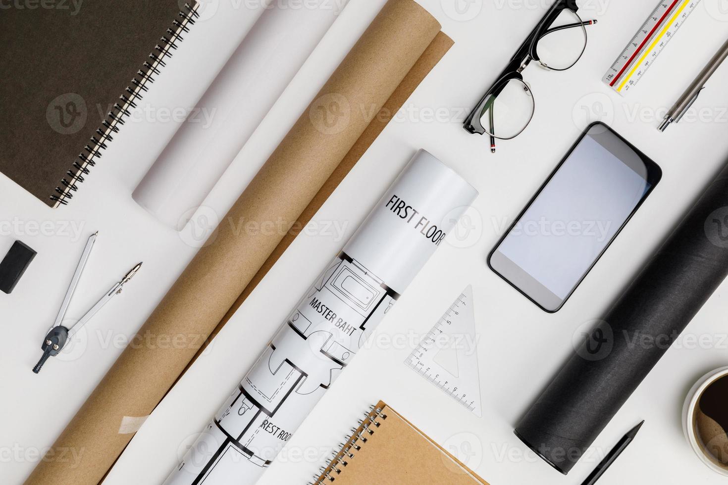 Creative flat lay of architects white table with roll blueprints, architectural project plan, engineering tools, office supplies and a cup of hot coffee,Workspace for designer concept photo