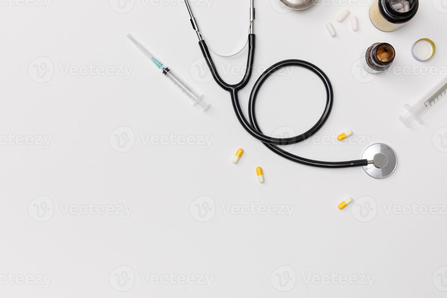 Creative flatlay of doctor medical equipment white table with stethoscope, medical documents, thermometer, syringe and pills, Health care concept, Top view with copy space, Isolated on white photo