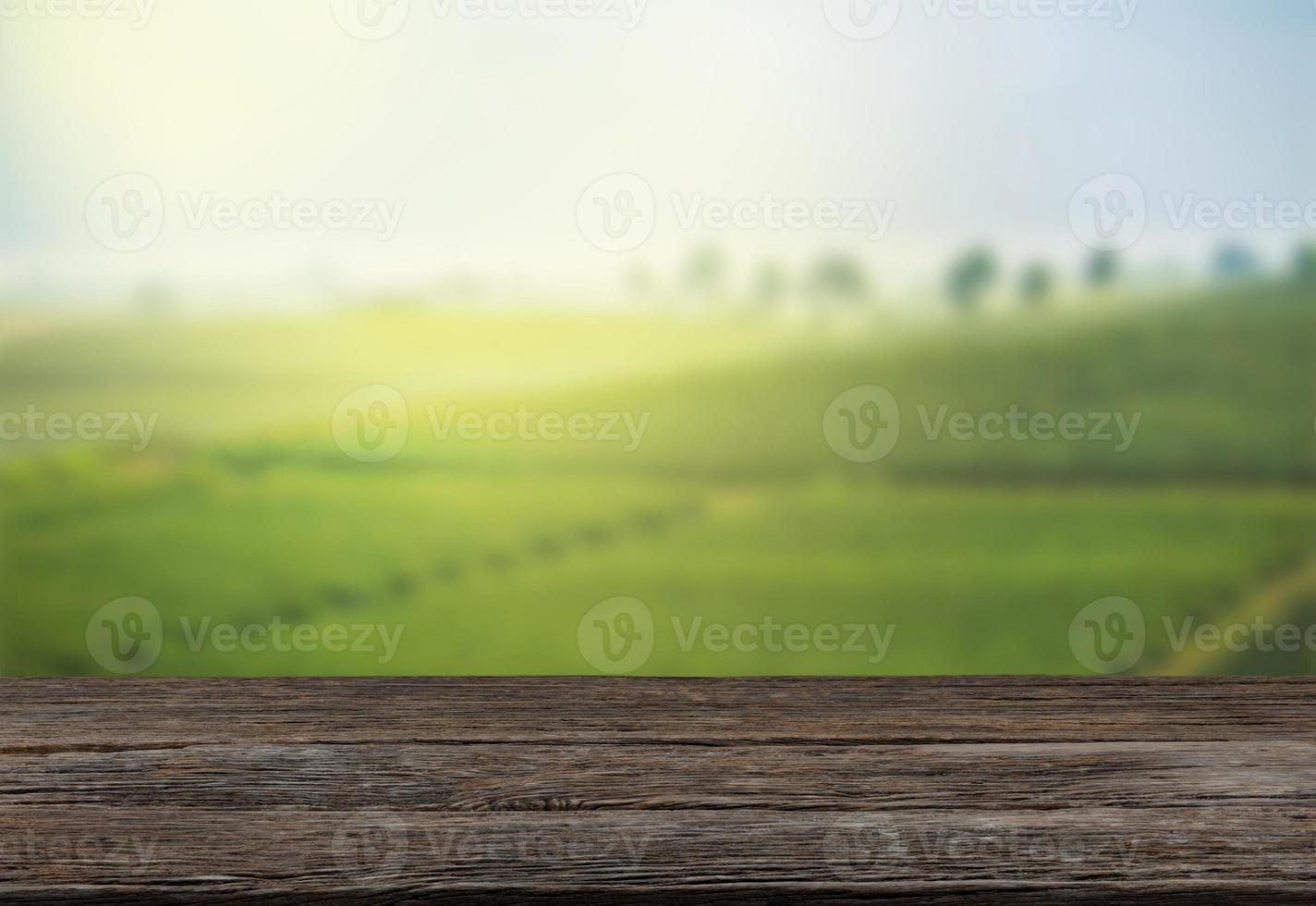Empty wooden table with view of mountain or wooden desk with plantation nature with bokeh background, copy space for your text photo