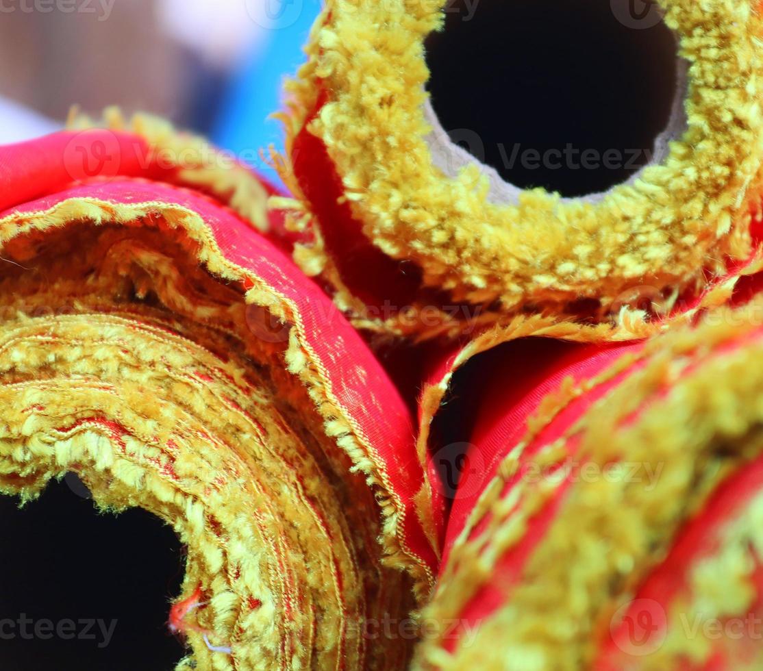 Detailed close up view on samples of cloth and fabrics in different colors found at a fabrics market photo