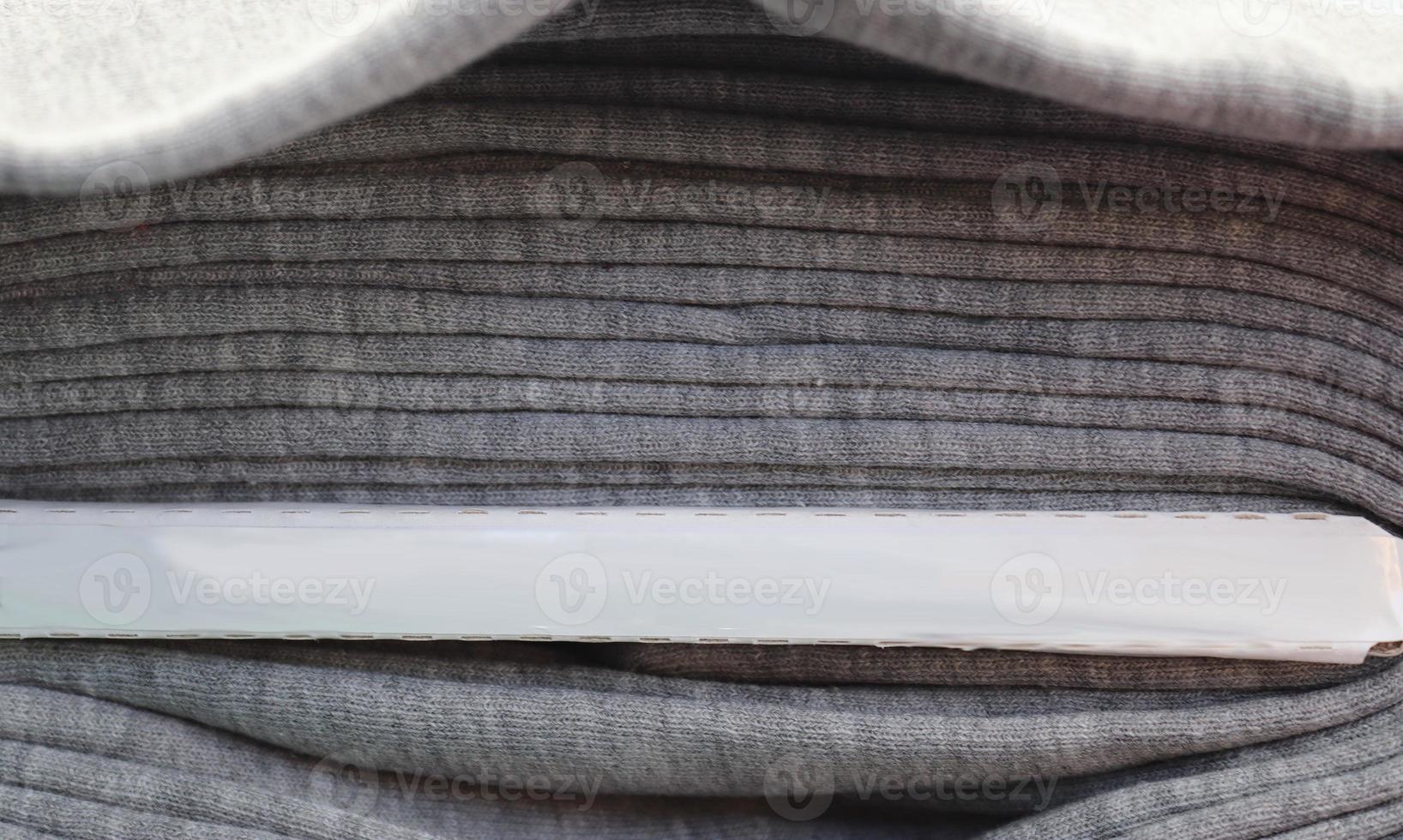 Detailed close up view on samples of cloth and fabrics in different colors found at a fabrics market photo
