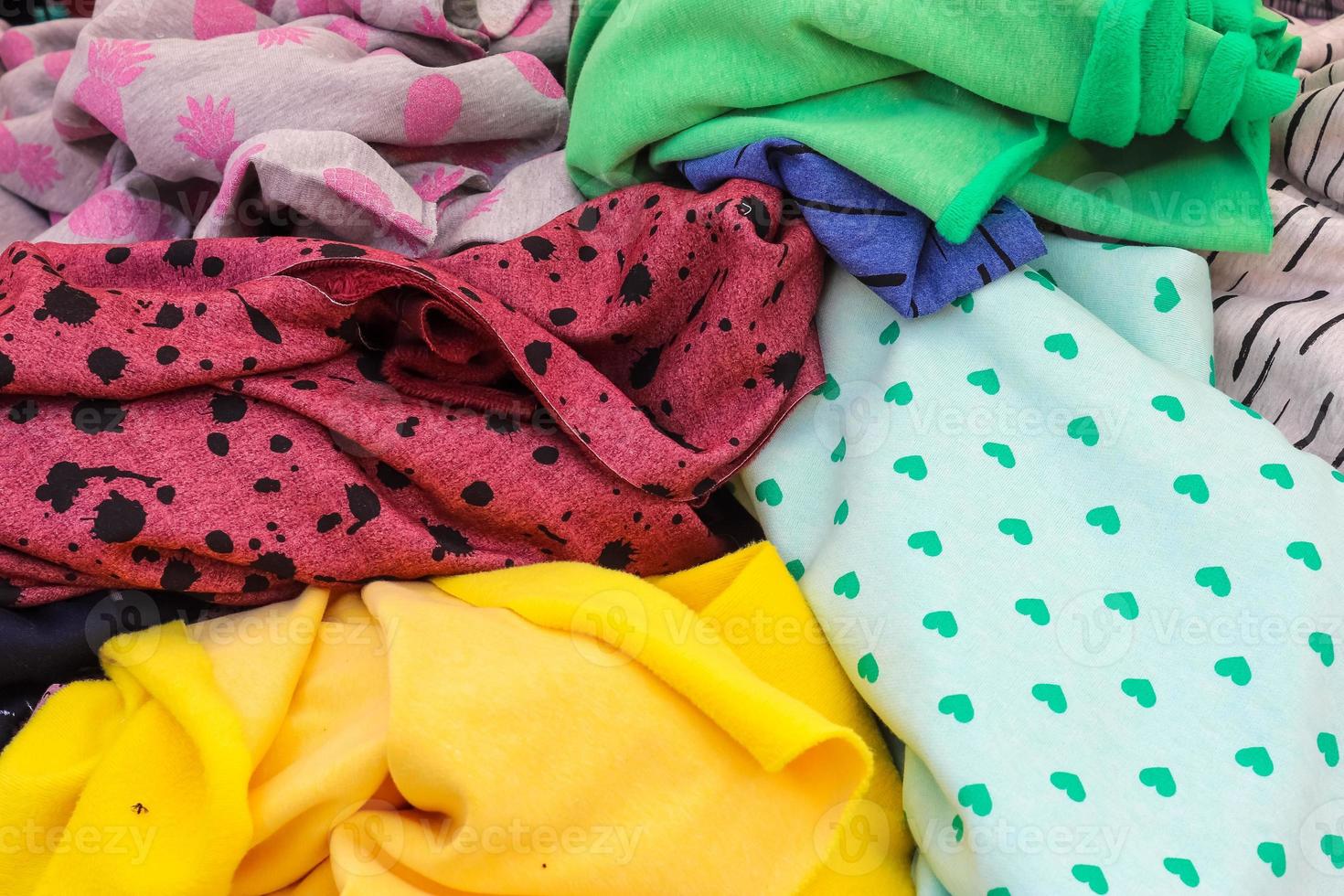 Detailed close up view on samples of cloth and fabrics in different colors found at a fabrics market photo
