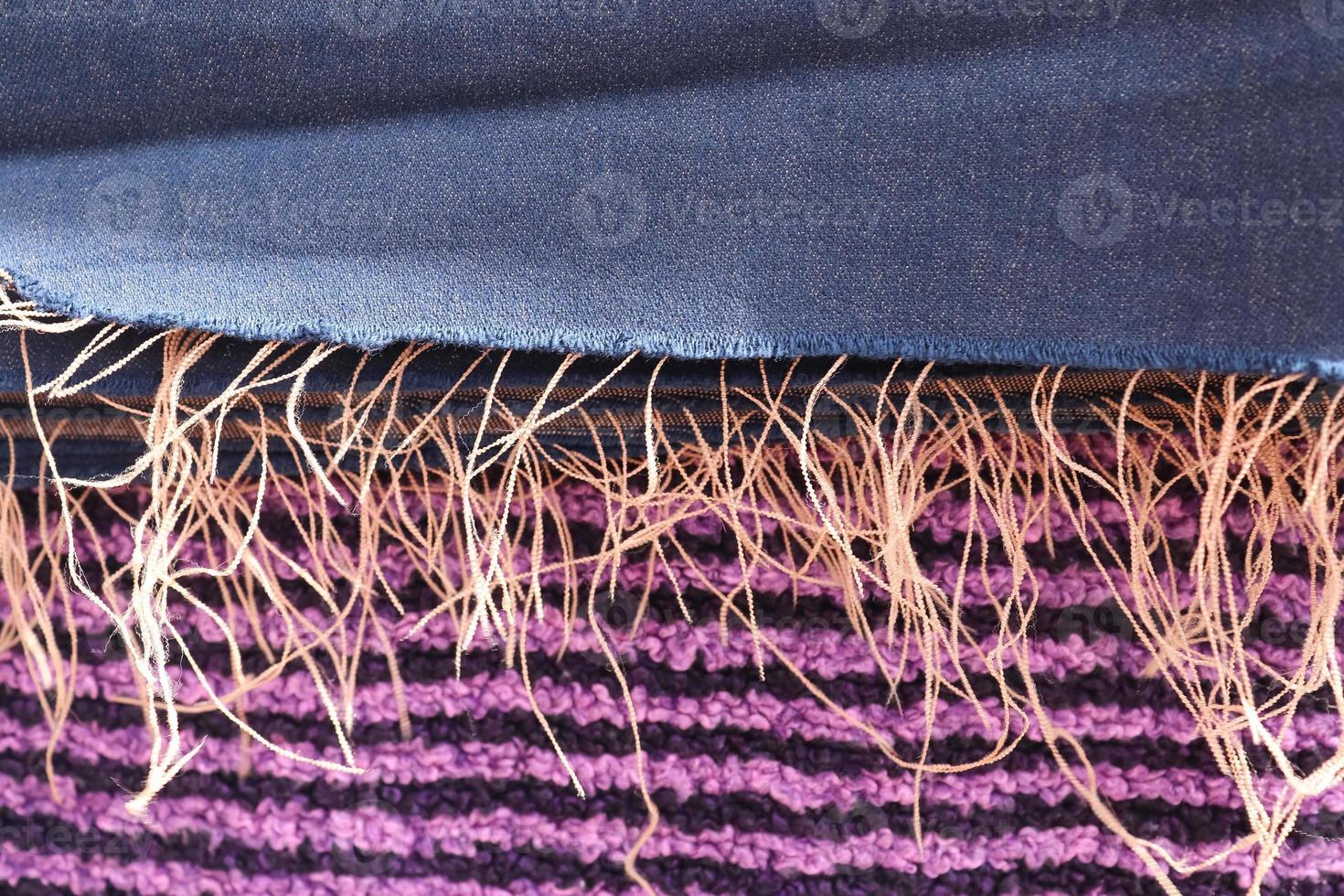 Detailed close up view on samples of cloth and fabrics in different colors found at a fabrics market photo
