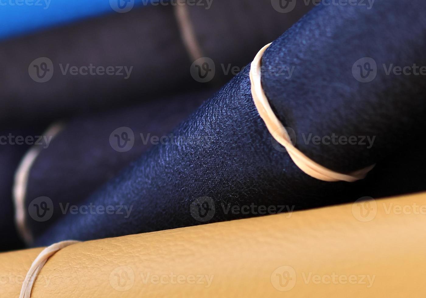 Detailed close up view on samples of cloth and fabrics in different colors found at a fabrics market photo