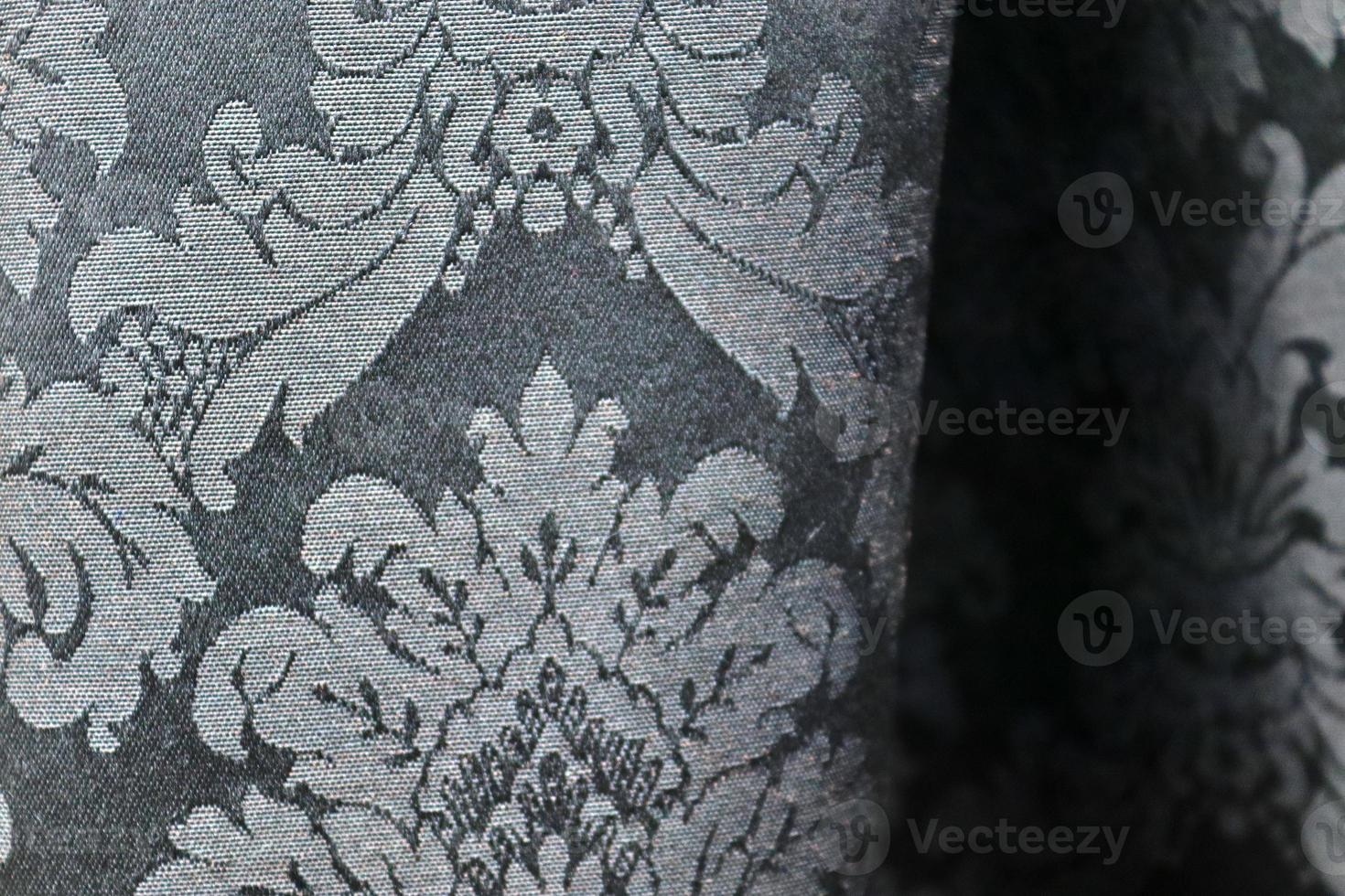 Detailed close up view on samples of cloth and fabrics in different colors found at a fabrics market photo