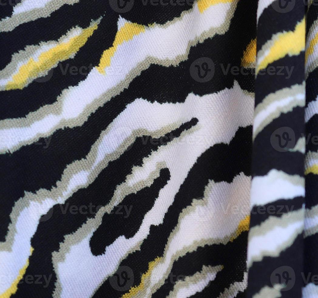 Detailed close up view on samples of cloth and fabrics in different colors found at a fabrics market photo