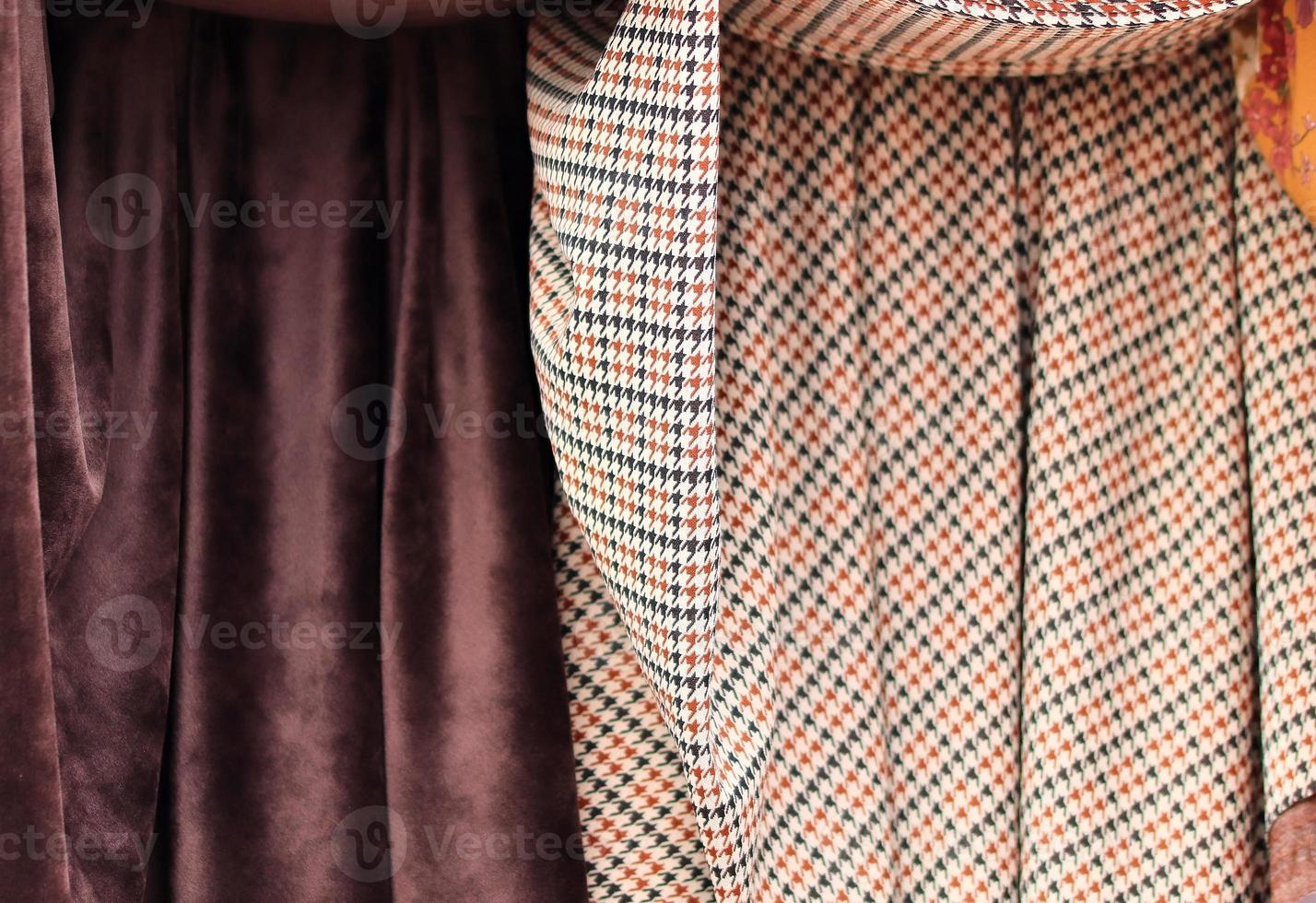 Detailed close up view on samples of cloth and fabrics in different colors found at a fabrics market photo