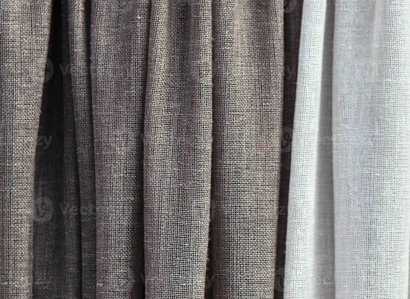 Detailed close up view on samples of cloth and fabrics in different colors found at a fabrics market photo