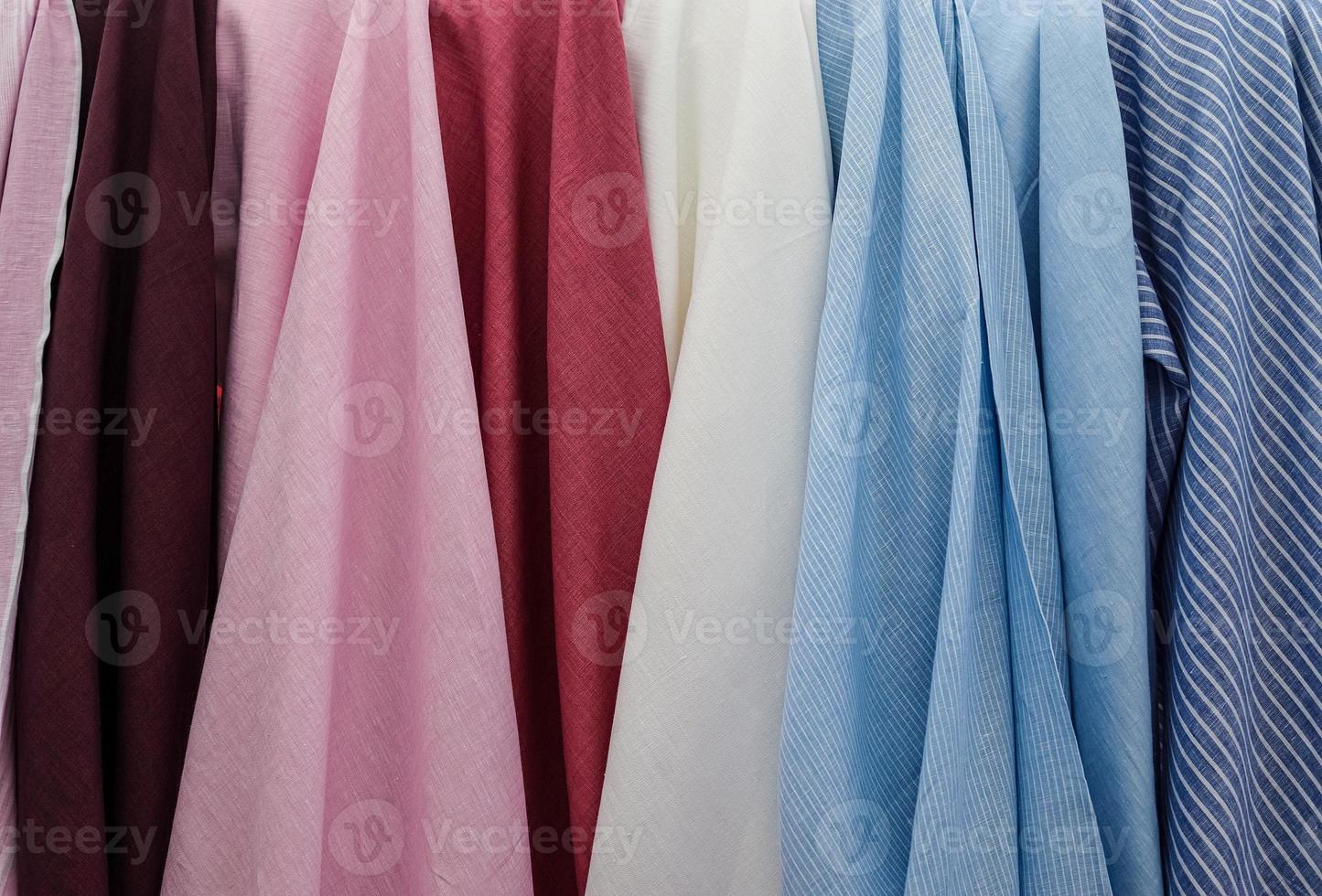 Detailed close up view on samples of cloth and fabrics in different colors found at a fabrics market photo