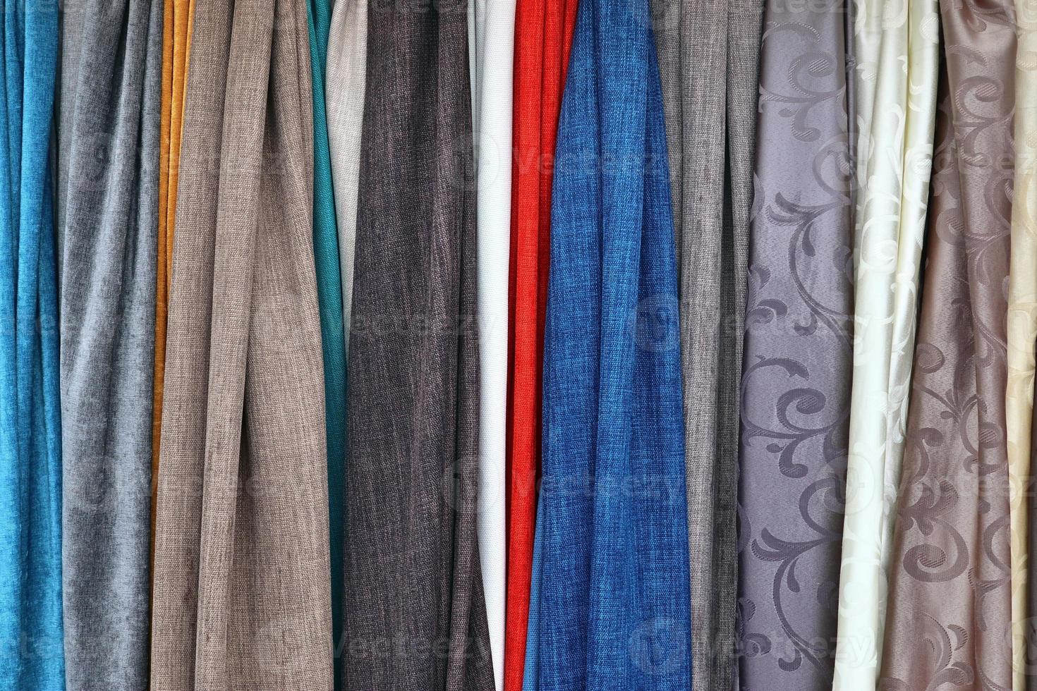 Detailed close up view on samples of cloth and fabrics in different colors found at a fabrics market photo