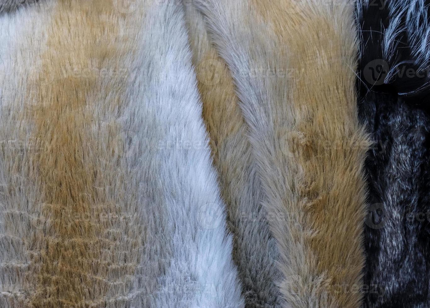 Detailed close up view on samples of cloth and fabrics in different colors found at a fabrics market photo