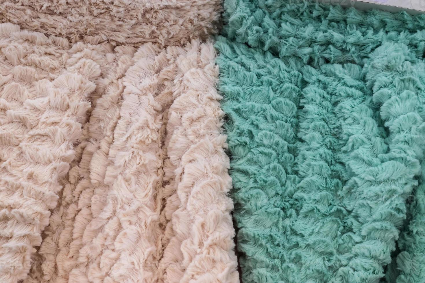 Detailed close up view on samples of cloth and fabrics in different colors found at a fabrics market photo