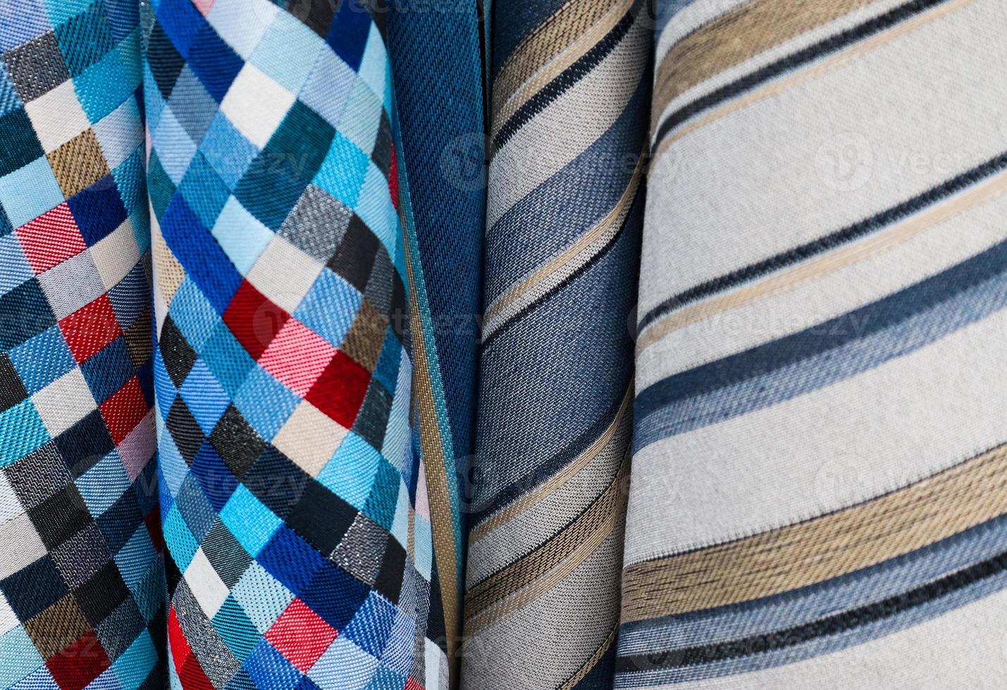 Detailed close up view on samples of cloth and fabrics in different colors found at a fabrics market photo