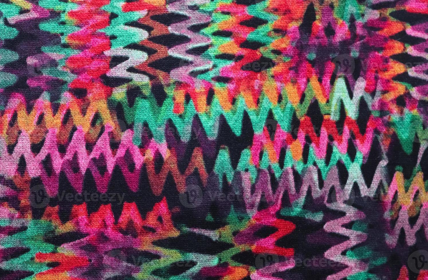 Detailed close up view on samples of cloth and fabrics in different colors found at a fabrics market photo