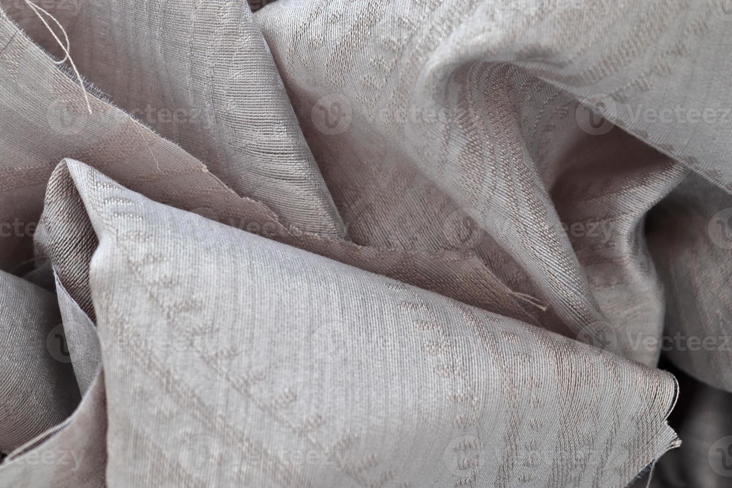 Detailed close up view on samples of cloth and fabrics in different colors found at a fabrics market photo