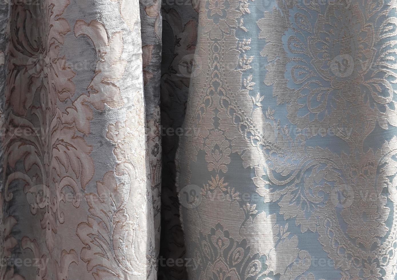 Detailed close up view on samples of cloth and fabrics in different colors found at a fabrics market photo