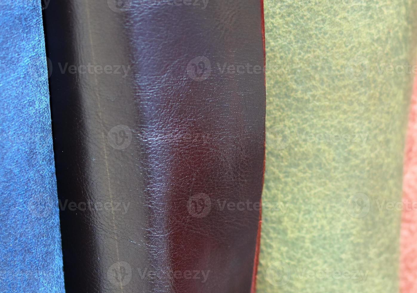 Detailed close up view on samples of cloth and fabrics in different colors found at a fabrics market photo