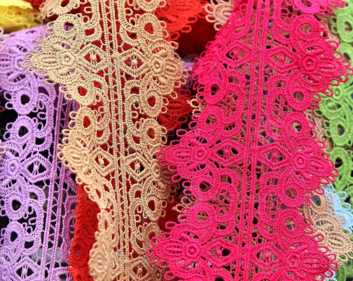 Detailed close up view on samples of cloth and fabrics in different colors found at a fabrics market photo