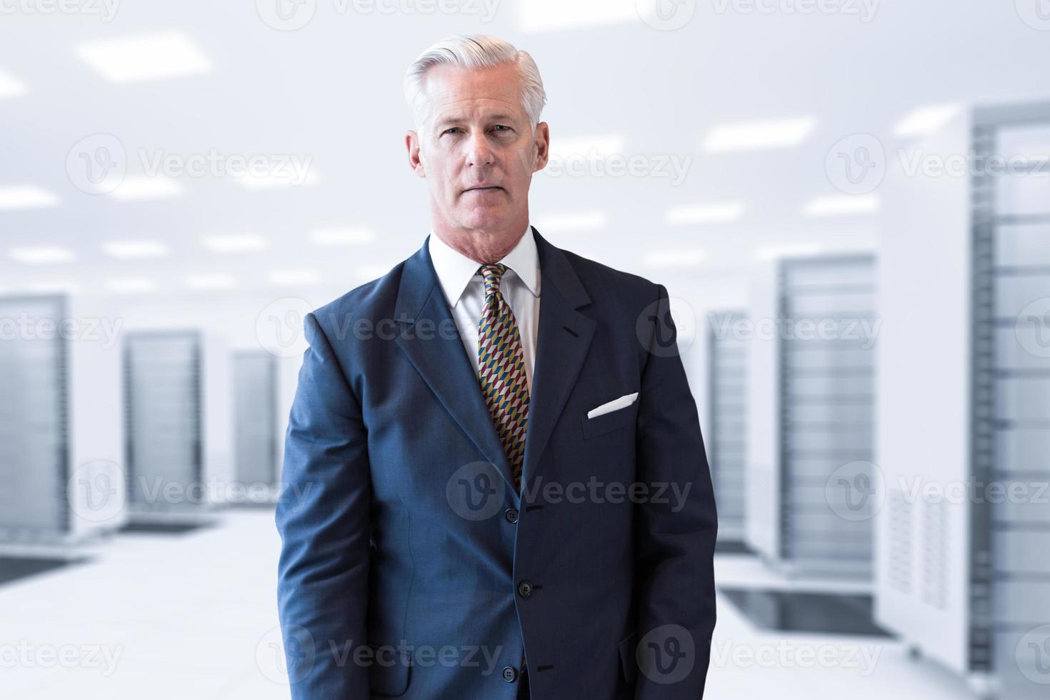 Senior businessman in server room photo